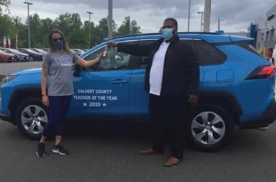 2-people-in-front-of-toyota-car.jpeg