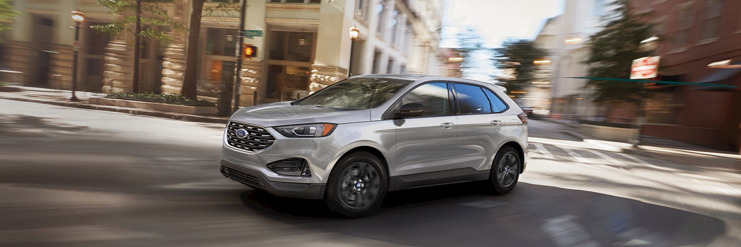 Silver Ford Edge driving in city