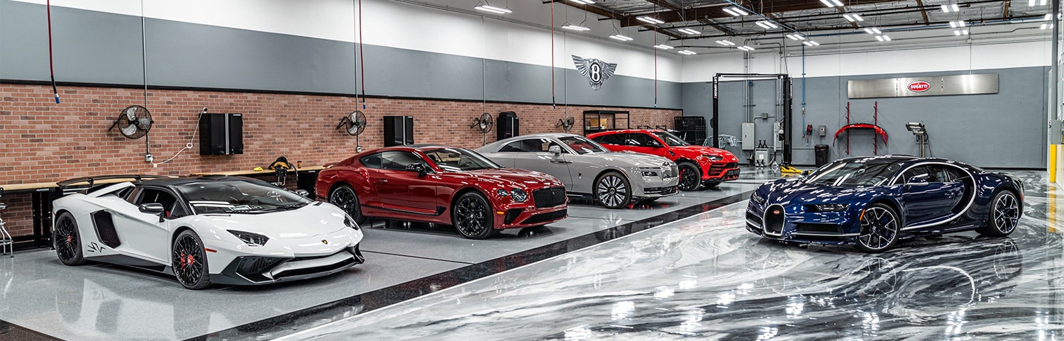 San Diego Luxury Motors body shop with exotic cars in the bay
