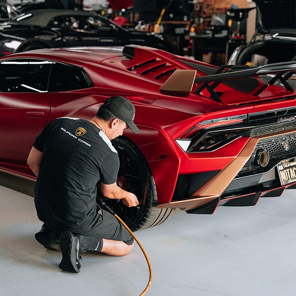 San Diego Luxury Motors body shop with a lambo in the bay
