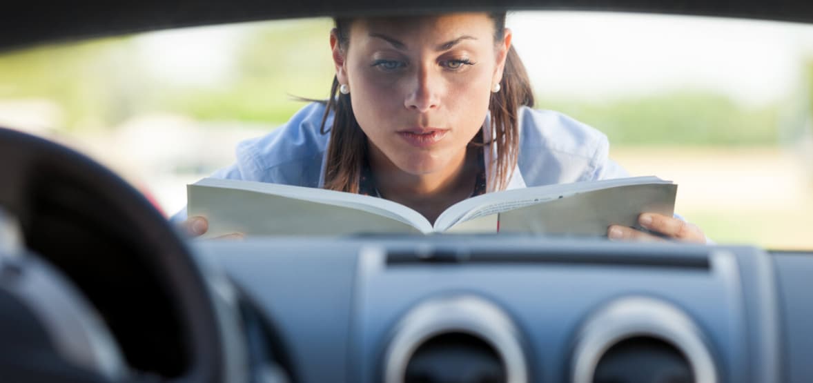  Mazda owner looking at car manual
