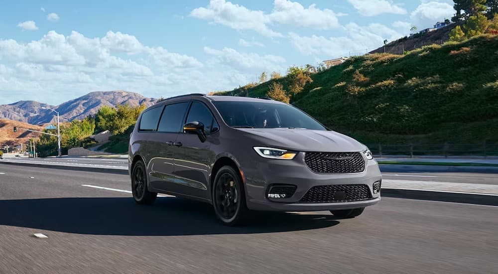 A grey 2024 Chrysler Pacifica is shown from the front at an angle after leaving a Chrysler dealer.