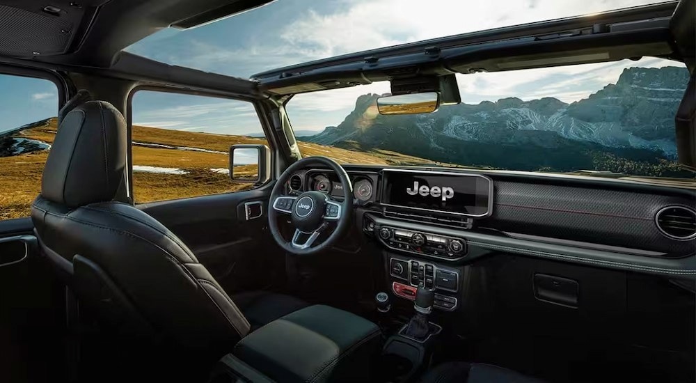 The black interior and dash in a 2024 Jeep Wrangler 4xe is shown.