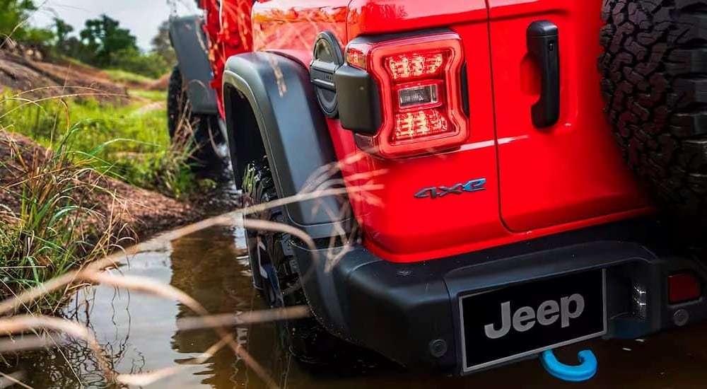 A close-up on the rear taillight on a red 2024 Jeep Wrangler 4xe is shown.