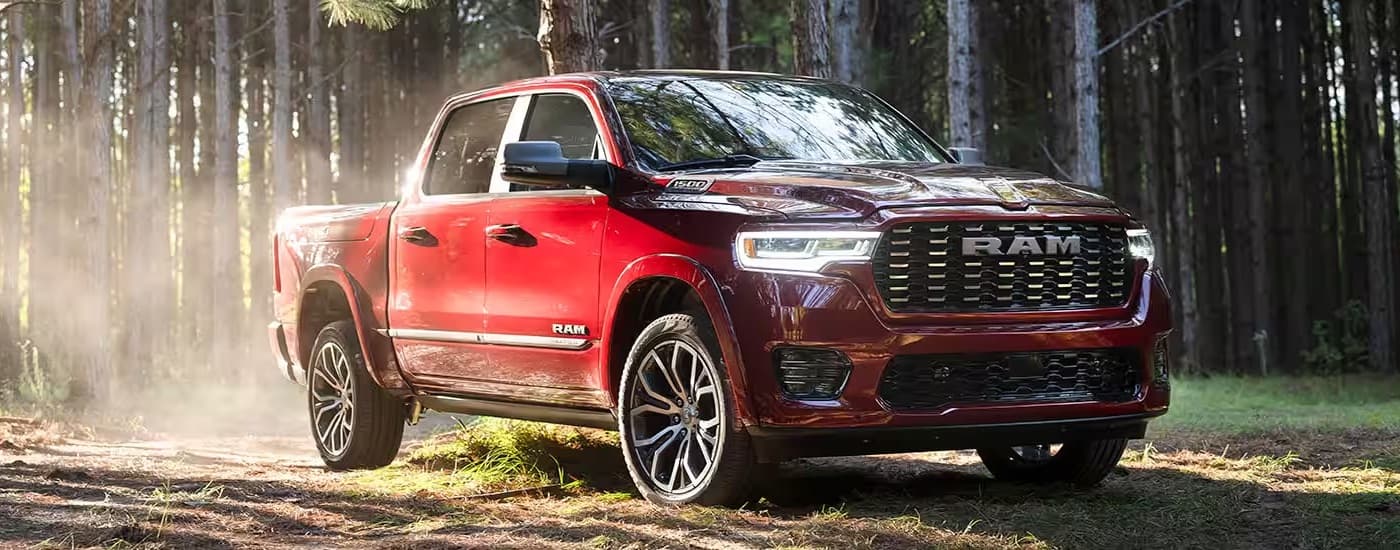 A red 2025 Ram 1500 is shown from the front at an angle after leaving a Ram dealer near Pittsfield.