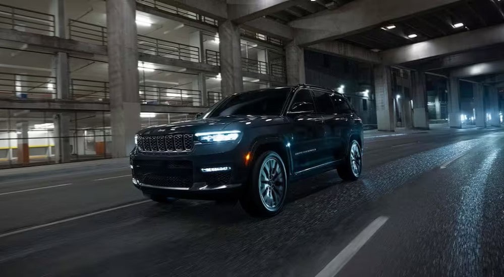A black 2025 Jeep Grand Cherokee is shown driving in a tunnel.