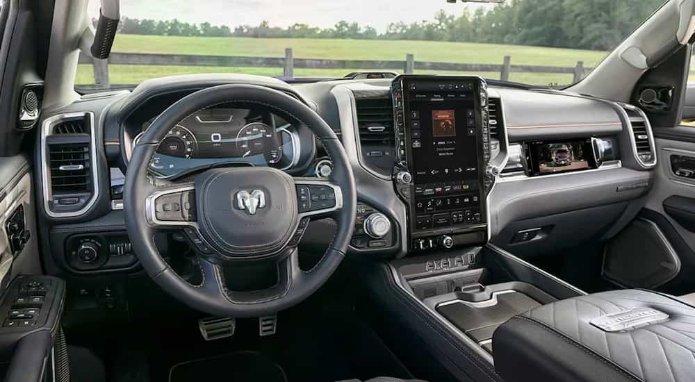 The black interior and steering wheel of a 2025 Ram 1500 Tungsten.