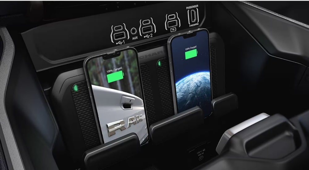 Close-up of the dual wireless charging pads in the cabin of a 2025 Ram 1500.