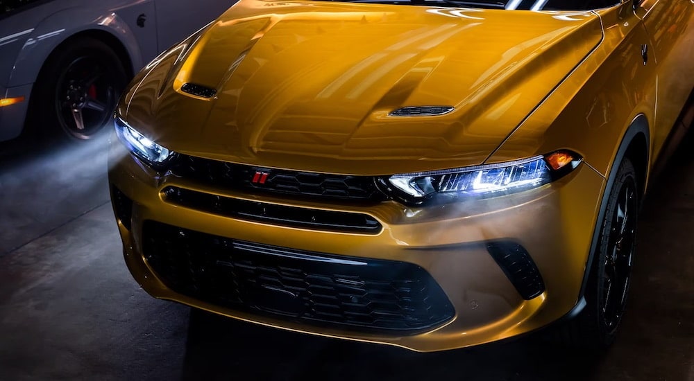 A yellow 2024 Dodge Hornet is shown from the front.