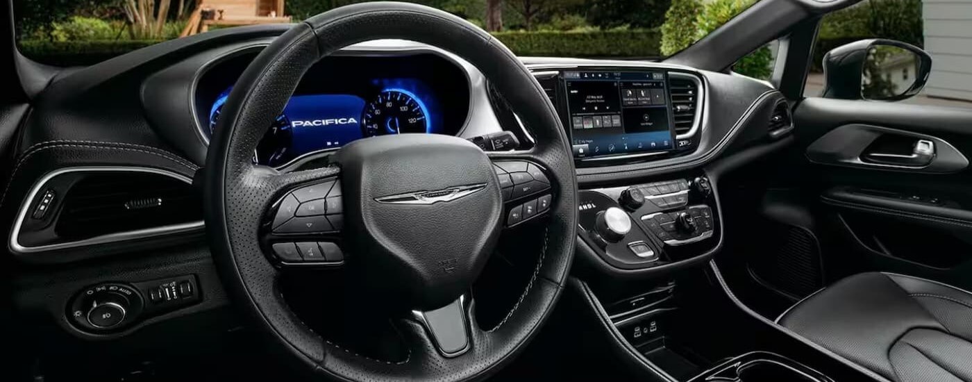 The black interior and dash in a 2024 Chrysler Pacifica is shown.
