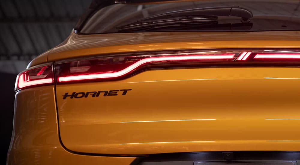 The taillights and Hornet badge on a yellow 2024 Dodge Hornet.