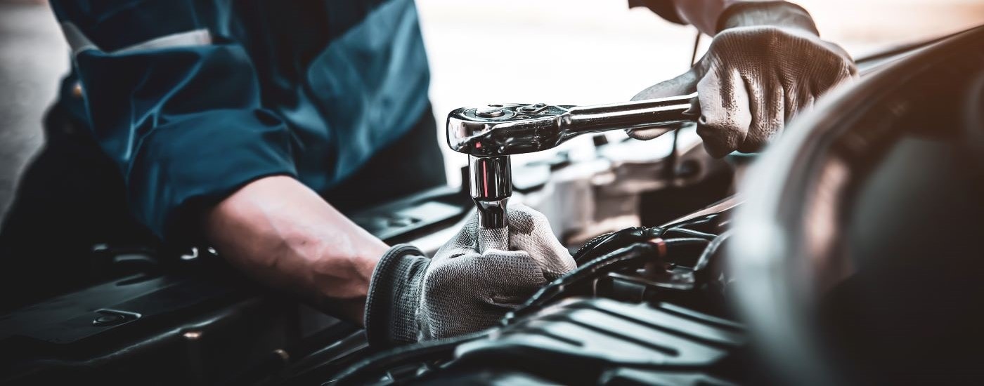 A technician is shown working on a vehicle.
