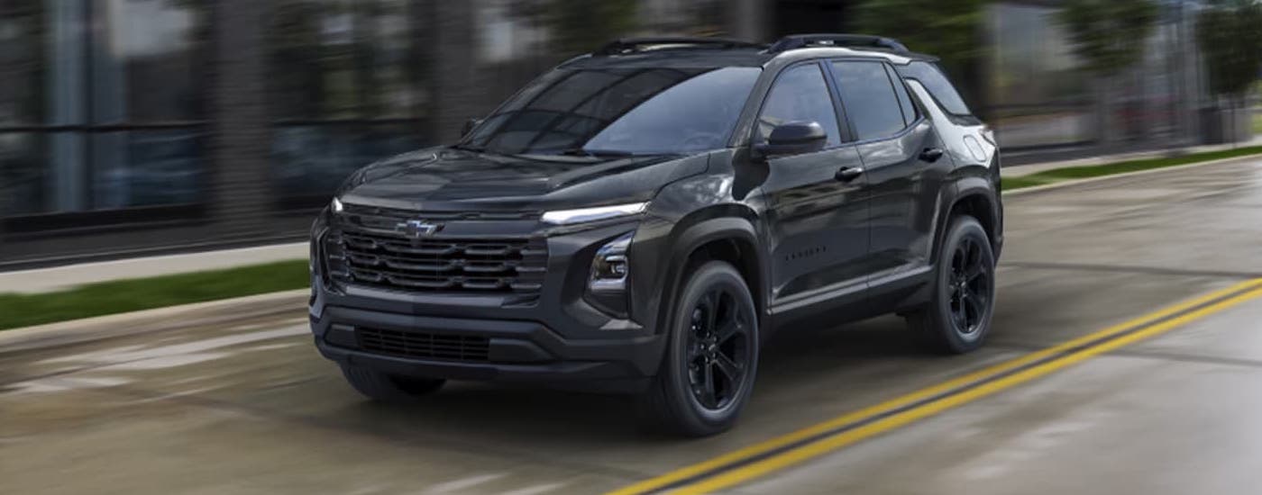 A black 2025 Chevy Equinox for sale in Cheshire is on a test drive.