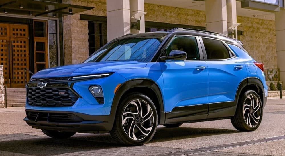 A blue 2024 Chevy Trailblazer RS is shown parked near a Chevy dealership near Pittsfield.