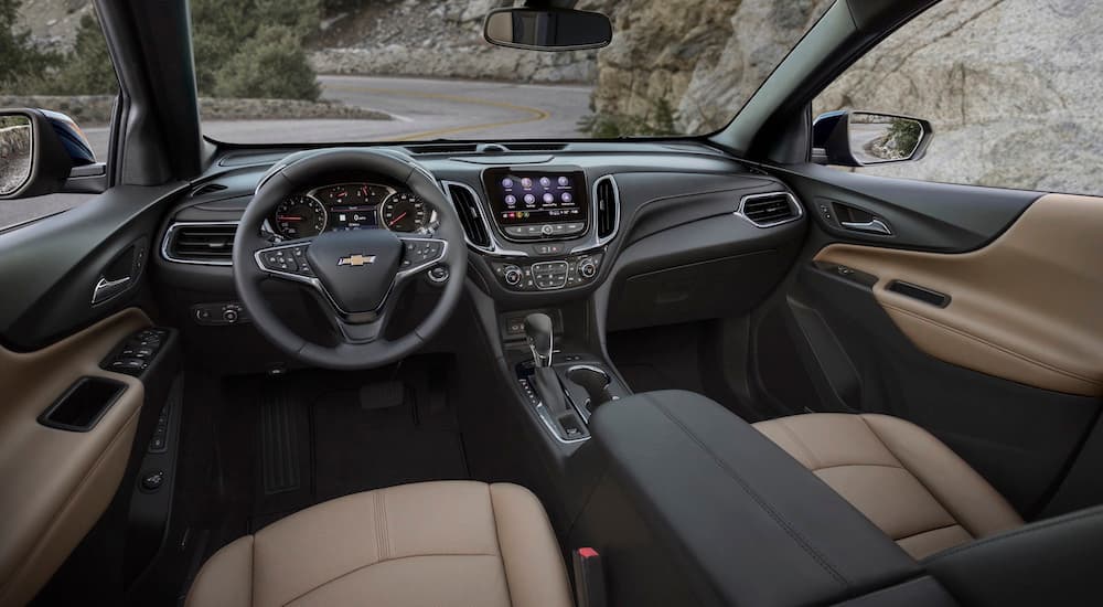 The brown interior of a 2024 Chevy Equinox Premier is shown from the driver's seat.