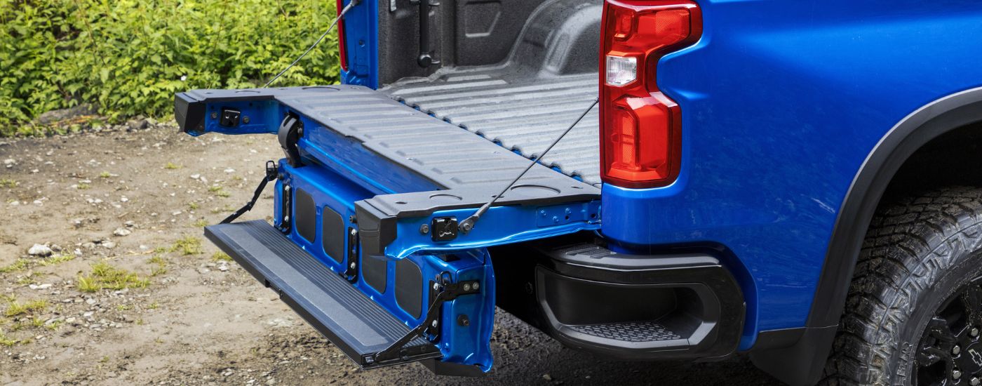 The open Multi-Flex Tailgate on a blue 2024 Chevy Silverado 1500 for sale near Bennington.