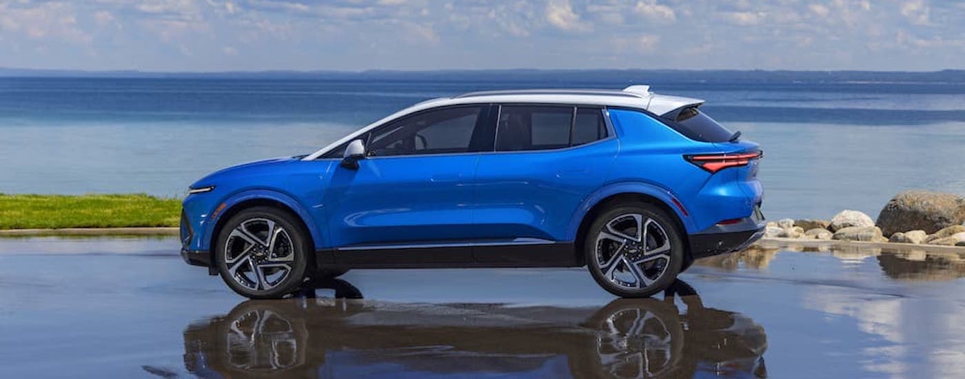 A blue 2024 Chevy Equinox EV is shown from the side.