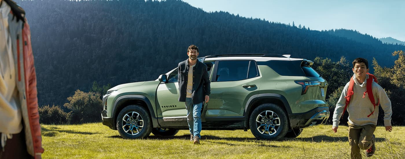 A green 2025 Chevy Equinox ACTIV parked on grass.