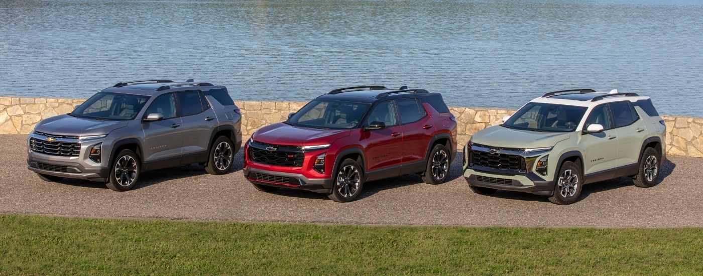 The trim lineup of the 2026 Chevy Equinox parked near a lake.