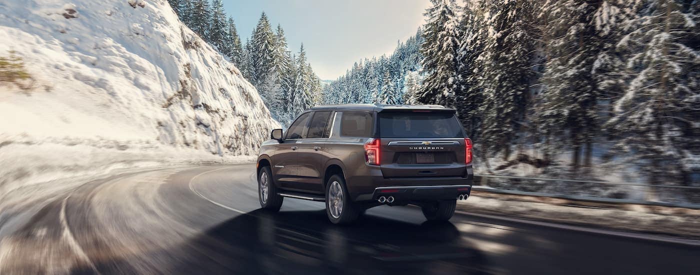 A grey 2022 Chevy Suburban is shown from the rear after leaving a Chevy dealership near Bennington.