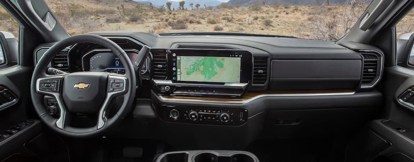 The black interior of a 2024 Chevy Silverado 1500 for sale is shown from above the center console.