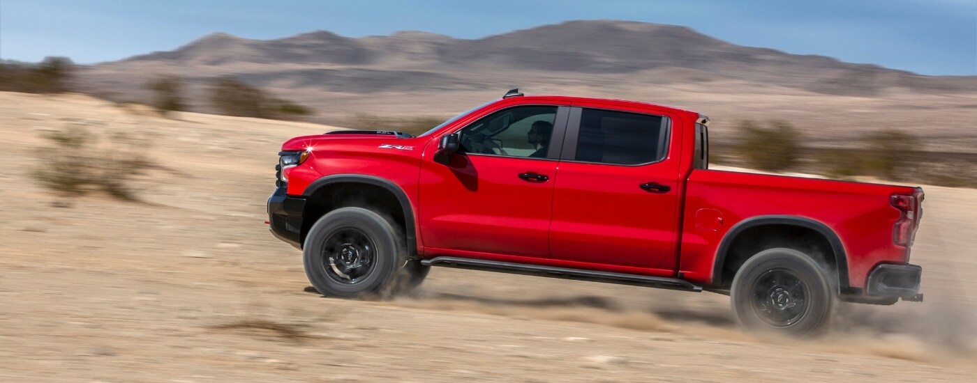 A red 2025 Chevy Silverado 1500 ZR2 is shown from the side.