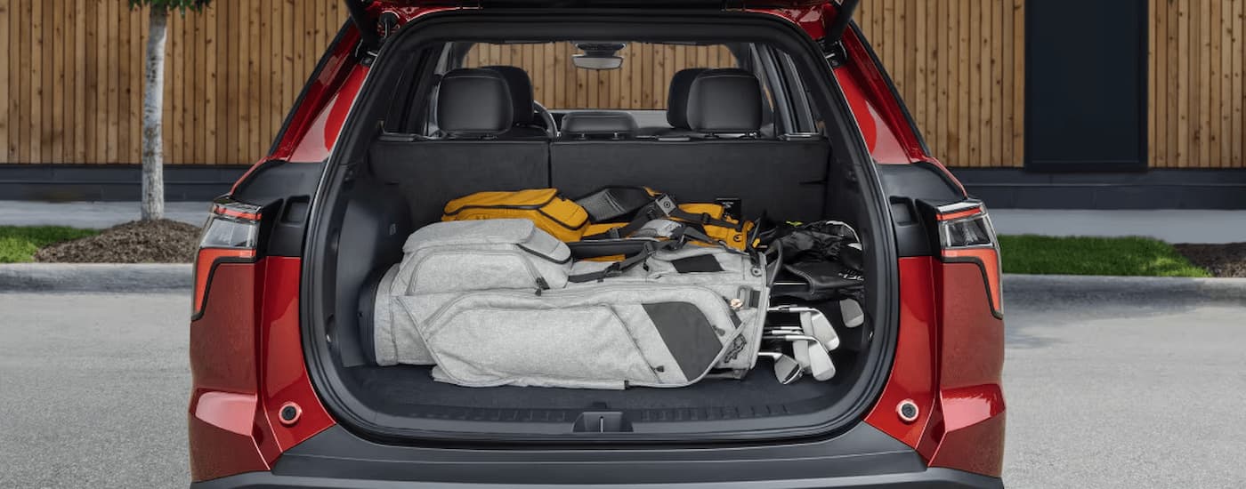 The rear cargo storage in a red 2025 Chevy Equinox.