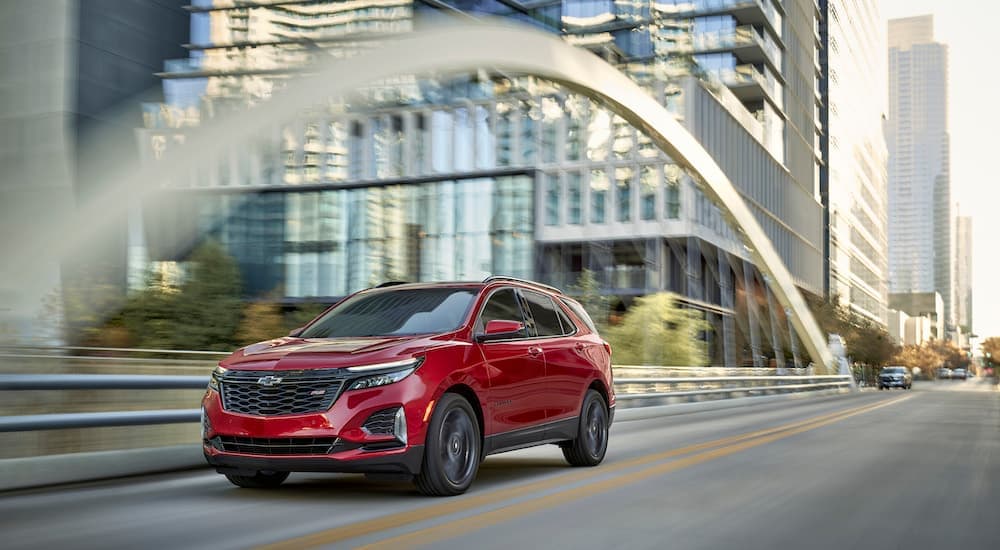 A red 2024 Chevy Equinox RS is shown from the front at an angle.