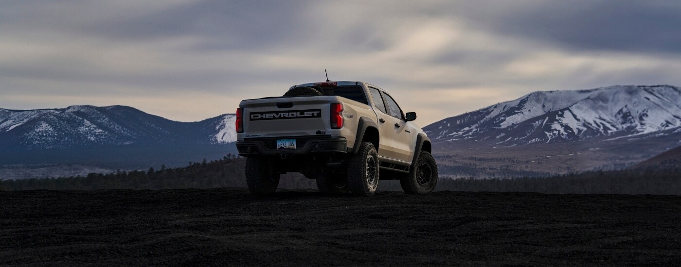 A tan 2024 Chevy Colorado ZR2 Bison overlooking mountains.