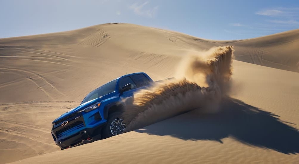 A blue 2024 Chevy Colorado ZR2 is shown off-roading.