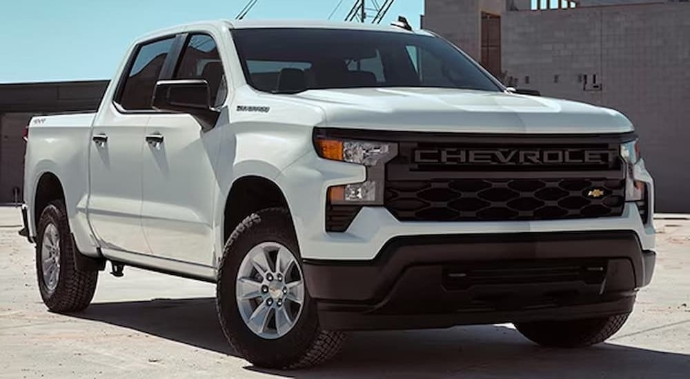 A white 2024 Chevy Silverado 1500 Custom is parked off-road.