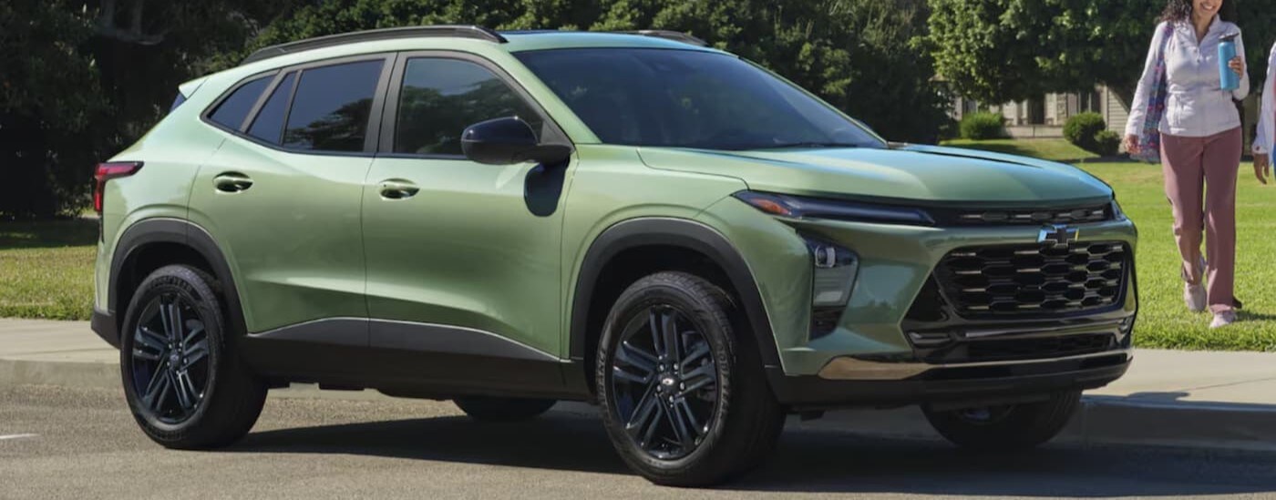 A green 2025 Chevy Trax ACTIV is shown parked on a sunny day.