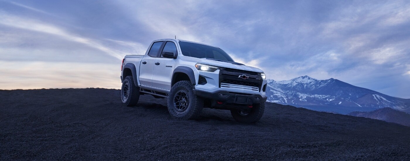 A white 2024 Chevy Colorado ZR2 Bison is overlooking mountains.