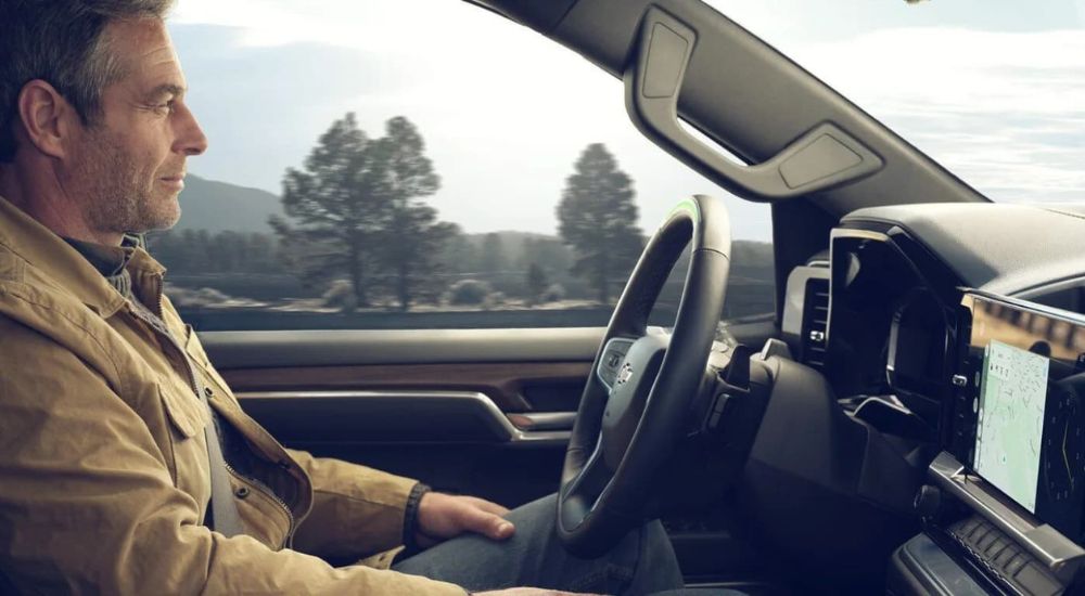 A man sitting using Super Cruise in the driver's seat of a 2024 Chevy Silverado 1500.