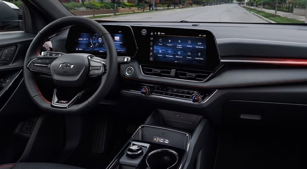 The black and red interior of a 2025 Chevy Equinox at a Chevy dealer near Northampton.