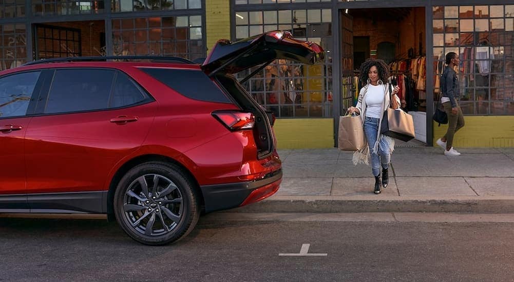 The hatch of a red 2024 Chevy Equinox RS is shown open.
