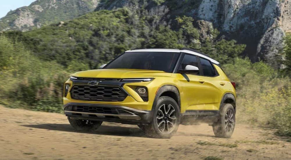A yellow 2025 Chevy Trailblazer ACTIV is shown driving off-road