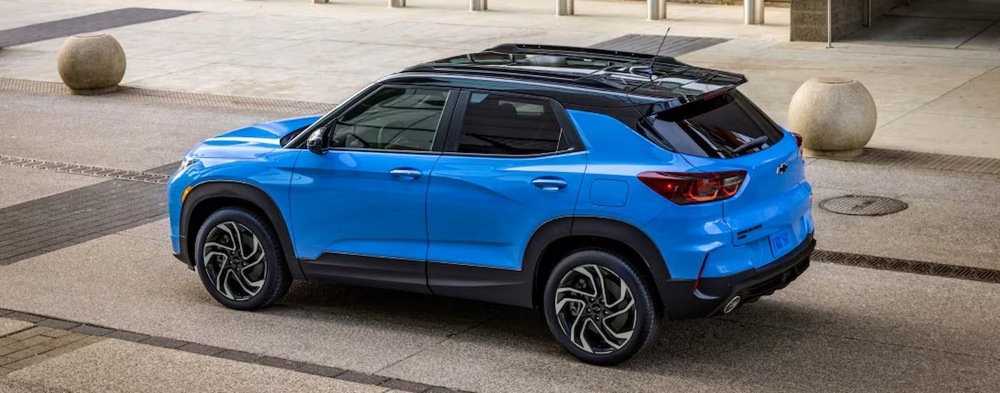 A blue 2024 Chevy Trailblazer RS is shown from the side parked on a brick road.