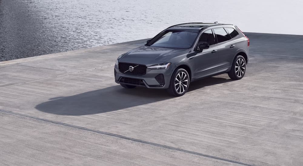 A grey 2024 Volvo XC60 is shown from the front at an angle after leaving a Volvo dealership