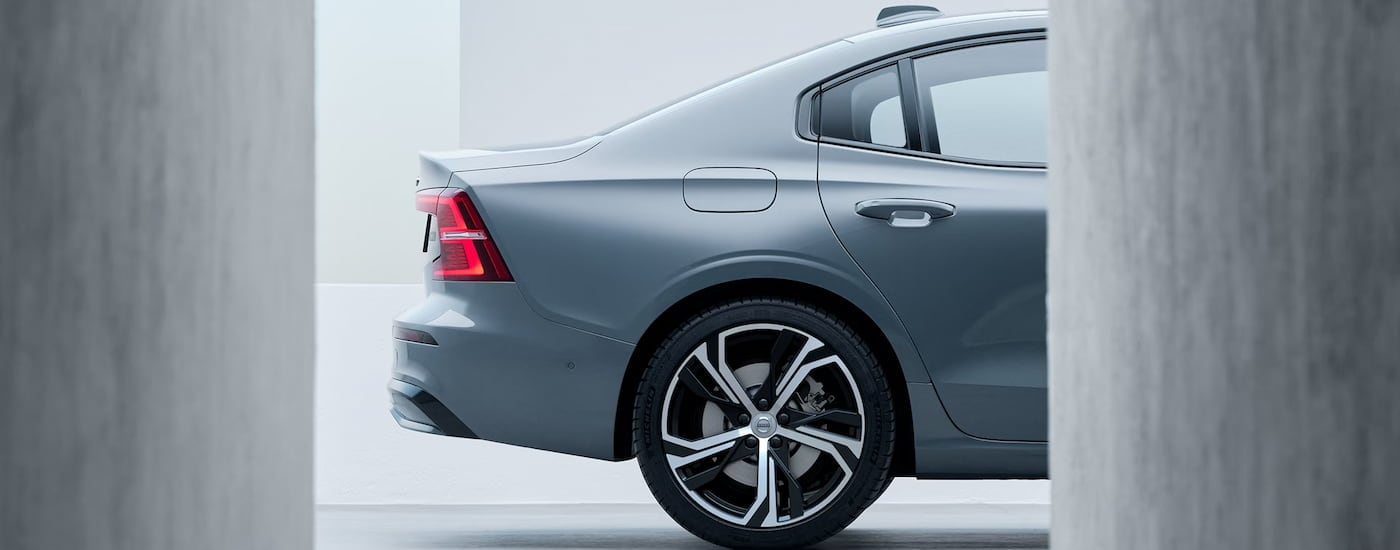 The rear half of a grey 2024 Volvo S60 is shown.