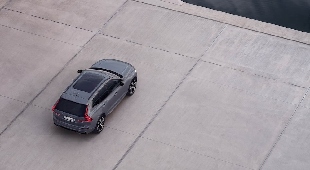 A grey 2024 Volvo XC60 is shown from the rear at a high angle.