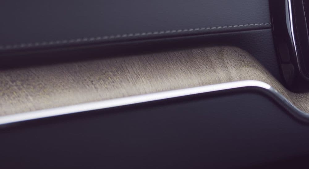 A close-up shows wood grain detailing in a 2024 Volvo XC60.