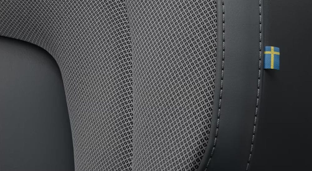 A close-up shows the black seat in a 2024 Volvo S60.