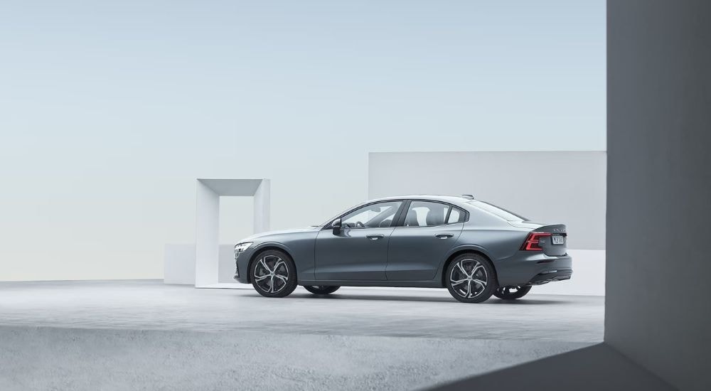 A blue 2024 Volvo S60 is shown for the side after leaving a Volvo dealership near Lenox.
