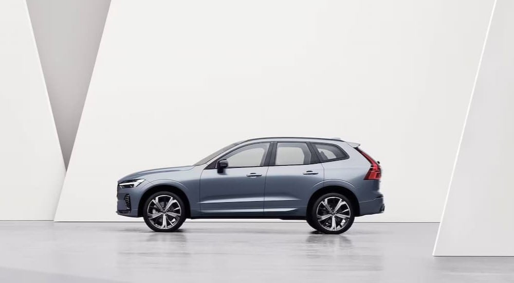 A silver 2024 Volvo XC60 is shown parked near a Volvo dealership near Pittsfield.