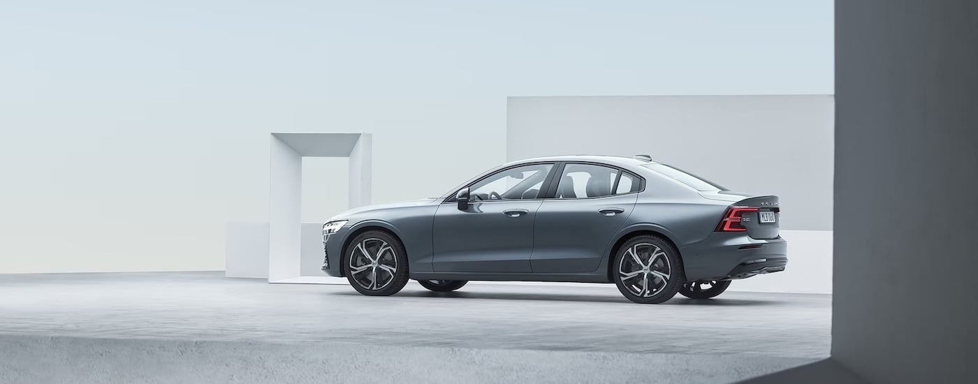 A grey 2024 Volvo S60 is shown from the side after leaving a Volvo dealer near Lee.