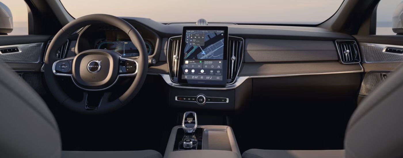The dashboard, steering wheel, and infotainment screens in a 2025 Volvo XC90.