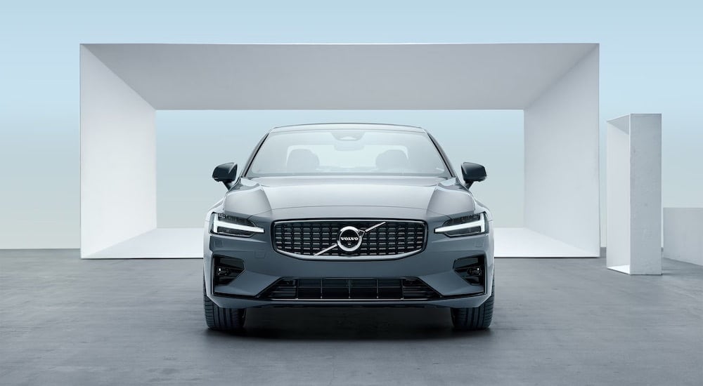 A grey 2024 Volvo S60 is shown from the front at an angle after leaving a Volvo dealership near Lenox.