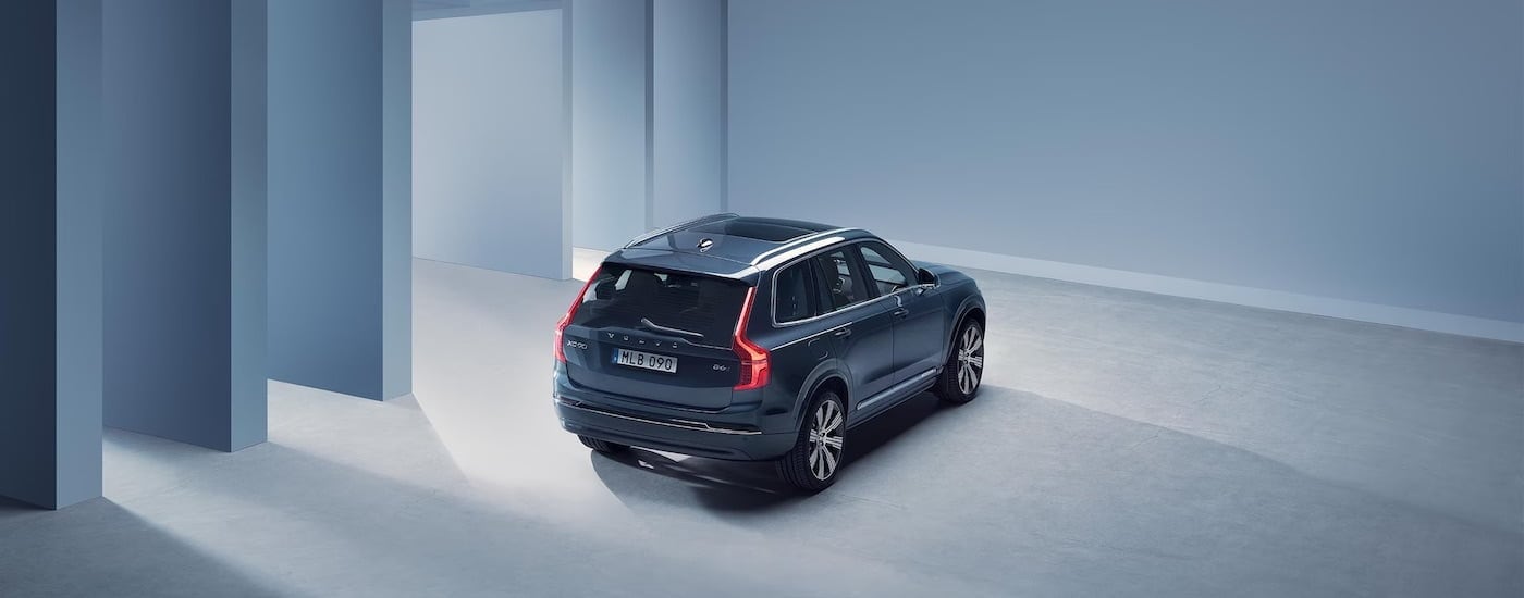 A grey 2024 Volvo XC90 is shown from the rear at an angle.