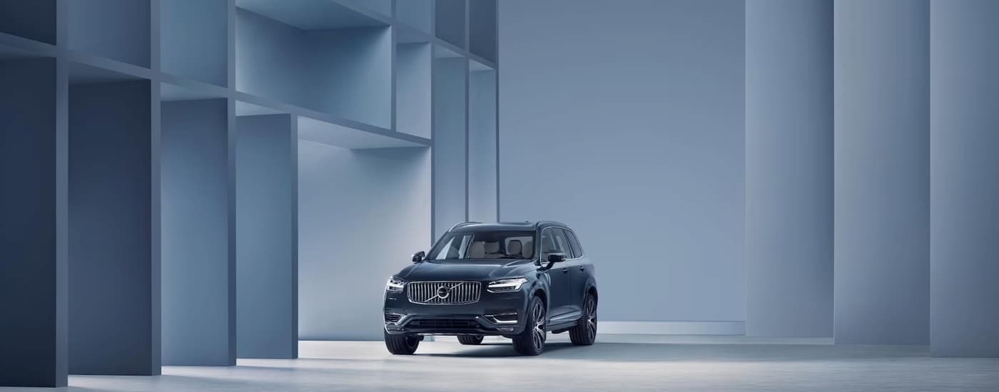 Volvo%20Dealer%20Near%20Stockbridge%20-%202024%20Volvo%20XC90%20-%20Architecture.jpg A blue 2024 Volvo XC90 parked in a showroom with modern architecture.